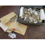 Mixed coins and stamps in a vintage metal cash tin