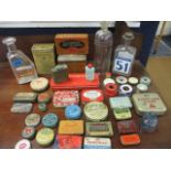 A quantity of vintage pharmaceutical tins and glass bottles