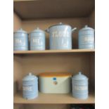 A quantity of vintage blue enamelled kitchen canisters and a modern blue metallic bread bin