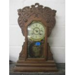 An early 20th century American New Haven Clock Company mantle clock in a carved mahogany case, 21