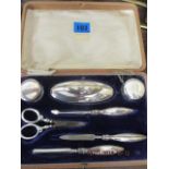 A silver manicure set, retailed by Harrods