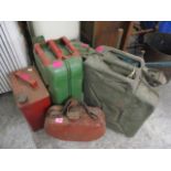 A selection of pre-war and later jerry and petrol cans to include two military issue cans and a