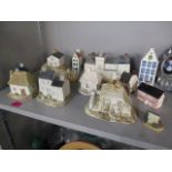 A mixed lot of ceramic model houses to include Royal Delft blue Holland and Royal Goedewaagen Delft