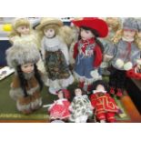 A collection of late 20th century dolls, all on stands