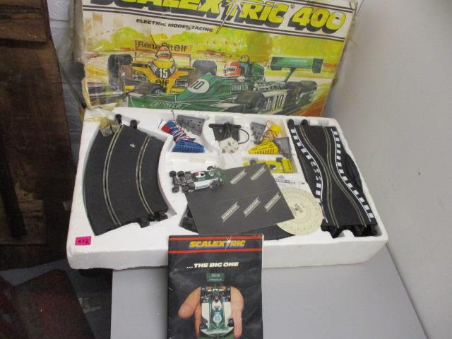 A Scalextric set with a six wheeled car