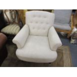 A modern cream upholstered armchair