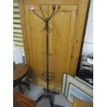 A wrought iron hat and stick stand, on splayed legs