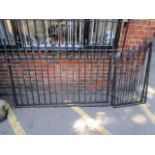 A pair of wrought iron black painted drive way gates and a pair of matching smaller gates