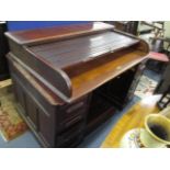 An early 20th century mahogany roll top twin pedestal desk, 38"h x 54"w x 35 1/2"d