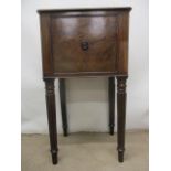 An Edwards & Roberts mahogany bedside cupboard having a door with a central turned handle, raised on