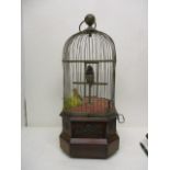 An early 20th century coin operated mahogany and brass, twin bird automaton with a carrying