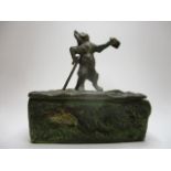 A painted cold cast bronze box, the hinged lid surmounted by a cat with a walking stick holding a