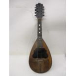 A late 19th century string inlaid, rosewood, softwood and tortoiseshell mandolin containing a