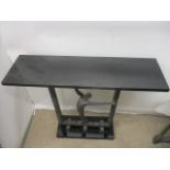 A contemporary cast bronze hall table having a black marble top