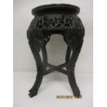 A late 19th century Chinese rosewood plant stand having an inset marble top over a carved and