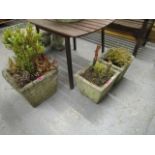 A large weathered stoneware planter of square form, and a pair of smaller similar planters