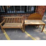 A folding garden table, a garden bench and a small table