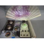 Three reproduction miniatures, a decorative Sloan Street fan, fruit knives, a lighter, a cigarette