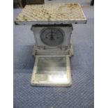 A white painted iron personal weighing machine with a folding mirror