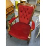 A late 19th century walnut carved, button back armchair