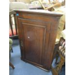 A George III corner cabinet, cross banded fielded panels, 42 1/4"h x 29 1/4"