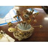 A mixed lot to include a model of a tortoise, a hen stick pin cushion with various stick pins, a