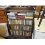 An early 20th century oak bookcase, 43" h x 30" w, containing mixed books