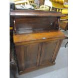 A William IV rosewood chiffoniere with raised back, twin panelled cupboards below, standing on a