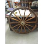 A Victorian fourteen spoke cart wheel with metal band, approximately 34" diameter