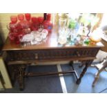 A 1930s oak single drawer side table with thumb moulded ornament, raised on baluster turned legs