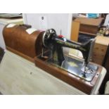 An early 20th century oak cased Singer sewing machine