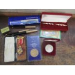 A mixed lot to include pens, a Masonic medal, matches, a one-dollar commemorative coin and other