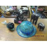 A mixed lot to include a Wedgwood Whale paperweight, a glass hat, two ebony carved elephants and