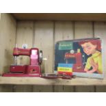 A retro Vulcan Senior child's sewing machine in red, boxed