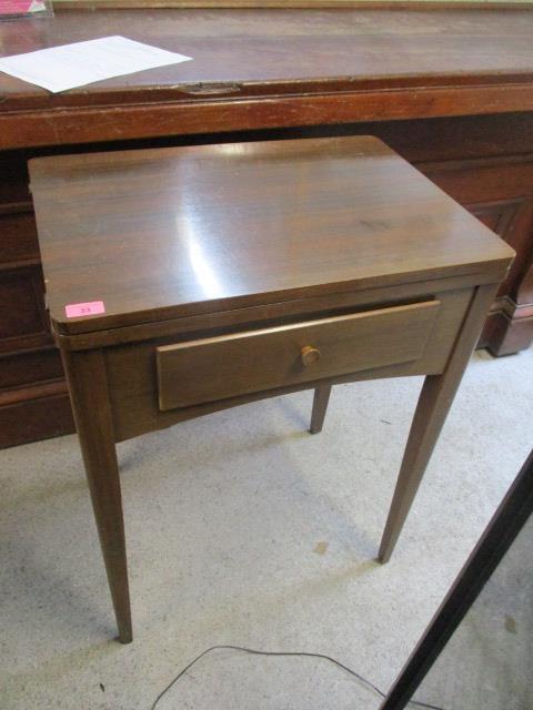 A mid 20th century teak table with inset Singer sewing machine