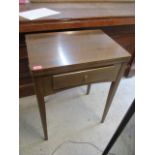 A mid 20th century teak table with inset Singer sewing machine
