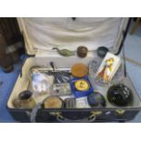 A vintage suitcase and contents to include a Russian tin plate doll and silver plate