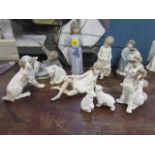 A group of Lladro and Nao porcelain figurines and animal models to include a boy playing with a