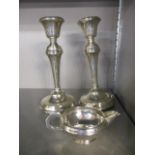 A pair of early 20th century silver candlesticks and a silver cream jug A/F