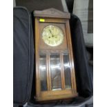 A carved oak cased wall clock (glass face missing)