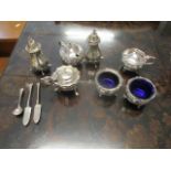 Silver condiments comprising two salts, three lidded mustards, two peppers, two butter knives and