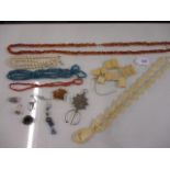 Jewellery to include a carved bone necklace and bracelet, coral necklaces, a 9ct gold ring, an amber