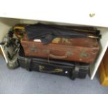 A large vintage leather suitcase and another, two walking canes, an umbrella, and a spelter figure