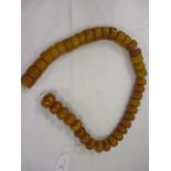 An Amber string of forty beads, 403.95 g