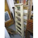 Two vintage pine step ladders, one painted white and a similar two section ladder