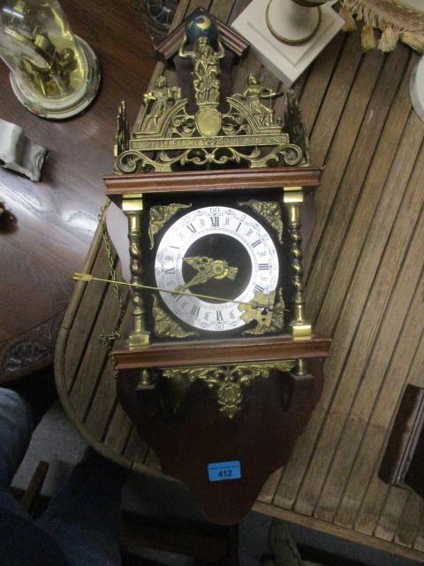 A modern mahogany and brass cased clock, surmounted by Atlas and two weights, 23" h
