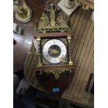 A modern mahogany and brass cased clock, surmounted by Atlas and two weights, 23" h