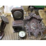 Three clocks to include a cuckoo clock, a Bakelite cased example and a 1930s oak cased mantel clock,