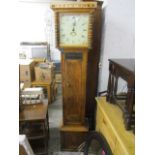 A Georgian pine 30 hour long case clock, the painted dial having Roman numerals and date ring to the