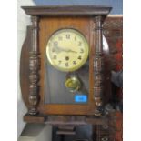A mahogany cased wall clock with cream coloured Arabic dial with single winding hole, with key and